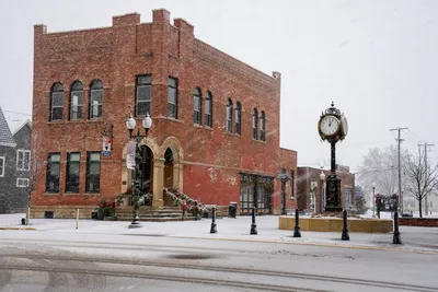 A historic brick building in Wabasha, Minnesota during a winter snowfall, showcasing vintage architecture.
